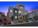 Contemporary home exterior featuring sleek design, desert landscaping, and inviting entrance at 11325 Gravitation Dr, Las Vegas, NV 89135