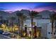 Inviting twilight view of modern homes with palm trees and mountain views at 11325 Gravitation Dr, Las Vegas, NV 89135