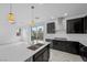Bright kitchen with a large center island, stainless steel appliances, and contemporary pendant lighting at 11325 Gravitation Dr, Las Vegas, NV 89135