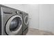 A convenient laundry room featuring modern, front-loading washer and dryer at 11325 Gravitation Dr, Las Vegas, NV 89135