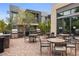 Outdoor kitchen and dining area with grills, tables, and seating for al fresco dining at 11325 Gravitation Dr, Las Vegas, NV 89135