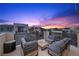 Enjoy the open air on this cozy rooftop patio with modern furniture and views of the surrounding community at 11325 Gravitation Dr, Las Vegas, NV 89135