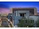 Modern home exteriors with balconies and city views at dusk at 11325 Gravitation Dr, Las Vegas, NV 89135