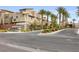 Attractive entrance to a community with modern architecture and lush landscaping at 11325 Gravitation Dr, Las Vegas, NV 89135
