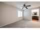 This neutral bedroom boasts plush carpet, ceiling fan, and a window with blinds at 11334 Colinward Ave, Las Vegas, NV 89135