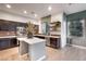 Modern kitchen features dark cabinets, stainless steel appliances, and a center island at 11334 Colinward Ave, Las Vegas, NV 89135