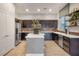 Well-appointed kitchen showcasing dark cabinetry, stainless appliances, and center island at 11334 Colinward Ave, Las Vegas, NV 89135