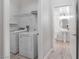 Functional laundry room featuring modern appliances and access to a half bathroom at 11334 Colinward Ave, Las Vegas, NV 89135