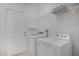 Bright laundry room with white washer, dryer, and storage shelves at 11334 Colinward Ave, Las Vegas, NV 89135
