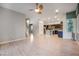 Spacious living area offers modern lighting, wood floors, and views of the open-concept kitchen at 11334 Colinward Ave, Las Vegas, NV 89135