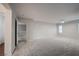 Spacious living room featuring neutral walls, carpet, and an open doorway at 11334 Colinward Ave, Las Vegas, NV 89135