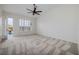 A light-filled bedroom features neutral carpet and a ceiling fan along with an exit to the pool at 1342 Calle Calma, Henderson, NV 89012