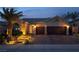 Well-lit front exterior features a multi-car garage, desert landscaping and brick paved driveway at 1342 Calle Calma, Henderson, NV 89012