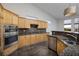 Spacious kitchen with granite counters, stainless appliances and eat-in breakfast bar at 1342 Calle Calma, Henderson, NV 89012