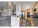 Open kitchen features granite countertops, stainless steel appliances, and a breakfast bar at 1342 Calle Calma, Henderson, NV 89012