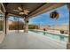 Covered patio next to pool with wrought iron spiral staircase, and ceiling fan at 1342 Calle Calma, Henderson, NV 89012