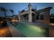 Backyard pool at twilight with exterior staircase leading to the covered patio above at 1342 Calle Calma, Henderson, NV 89012