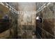The shower is beautifully tiled with slate-colored stones at 1342 Calle Calma, Henderson, NV 89012