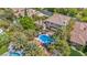 Aerial view of a large backyard with a pool, in-ground spa, patio and mature landscaping at 1409 Chambolle Ct, Las Vegas, NV 89144