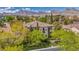 Expansive property showcasing a two-story stucco home, mature trees, and stunning mountain views in the distance at 1409 Chambolle Ct, Las Vegas, NV 89144