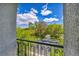 Bright balcony view of a well-maintained street with manicured lawns and mature trees at 1409 Chambolle Ct, Las Vegas, NV 89144
