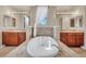Large bathroom featuring a soaking tub with granite surround, and and vanities at 1409 Chambolle Ct, Las Vegas, NV 89144