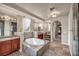 Luxurious bathroom with a soaking tub, granite countertops, and sinks, and a walk-in shower at 1409 Chambolle Ct, Las Vegas, NV 89144