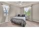 Cozy bedroom featuring a bed, two windows dressed in white curtains, and ceiling fan at 1409 Chambolle Ct, Las Vegas, NV 89144