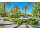 Beautifully landscaped community area with a decorative fountain, benches, and manicured greenery at 1409 Chambolle Ct, Las Vegas, NV 89144