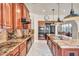 Spacious kitchen with granite countertops, wooden cabinets, stainless steel appliances, and modern lighting fixtures at 1409 Chambolle Ct, Las Vegas, NV 89144