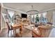 Spacious living room with a stone fireplace, hardwood floors, and large windows offering views of the backyard at 1409 Chambolle Ct, Las Vegas, NV 89144