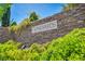 Stone wall displaying the 'Vineyards' community name, surrounded by vibrant green landscaping at 1409 Chambolle Ct, Las Vegas, NV 89144