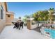 A balcony with outdoor seating overlooks a backyard pool and mature landscaping at 1922 Pyle, Las Vegas, NV 89183