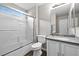 Bathroom featuring a shower-tub combo with sliding glass doors and a neutral color palette at 1922 Pyle, Las Vegas, NV 89183