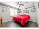 Cozy bedroom with red comforter, hardwood floors, ceiling fan, and ample shelf space at 1922 Pyle, Las Vegas, NV 89183
