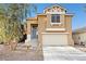 Inviting two-story home with a well-maintained front yard and attached garage at 1922 Pyle, Las Vegas, NV 89183