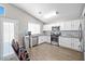 Bright kitchen with white cabinets, stainless steel appliances, and wood-look flooring at 1922 Pyle, Las Vegas, NV 89183