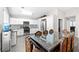 Eat-in kitchen showcasing white cabinetry, stainless steel appliances, and dining table at 1922 Pyle, Las Vegas, NV 89183