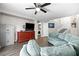 Inviting living room includes a ceiling fan, tv, a comfortable wrap-around couch, and convenient laundry access at 1922 Pyle, Las Vegas, NV 89183