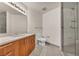Clean bathroom featuring a wood cabinet and glass shower at 200 W Sahara Ave # 2404, Las Vegas, NV 89102