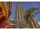 Stunning high-rise condo building with modern architecture and palm trees near the Las Vegas strip at 200 W Sahara Ave # 2404, Las Vegas, NV 89102