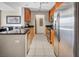 Well-lit kitchen features modern appliances, stone counters, wood cabinets, and tile floors at 200 W Sahara Ave # 2404, Las Vegas, NV 89102