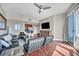 Spacious living room with ample seating, a TV, and sliding glass doors to a balcony at 200 W Sahara Ave # 2404, Las Vegas, NV 89102