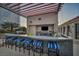 Inviting outdoor bar with grill, stainless steel appliances, barstool seating, and overhead pergola at 200 W Sahara Ave # 2404, Las Vegas, NV 89102