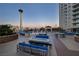 Amazing rooftop pool deck with seating, tables, and views of the Stratosphere Tower and surrounding landscape at 200 W Sahara Ave # 2404, Las Vegas, NV 89102