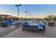 Expansive rooftop pool area featuring comfortable lounge seating, tables, and mountain views at sunset at 200 W Sahara Ave # 2404, Las Vegas, NV 89102
