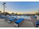 Serene swimming pool with lounge chairs, tables, and mountain views for relaxation and enjoyment at 200 W Sahara Ave # 2404, Las Vegas, NV 89102