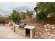 This yard features a built-in barbeque on a hardscaped area with rocks and mulch at 2007 High Mesa Dr, Henderson, NV 89012