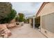 This hardscaped back yard features a covered patio with seating, a built-in barbeque and rock features at 2007 High Mesa Dr, Henderson, NV 89012