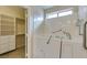 This bathroom features a walk-in tub with safety bars and a storage closet with shelving for linens at 2007 High Mesa Dr, Henderson, NV 89012